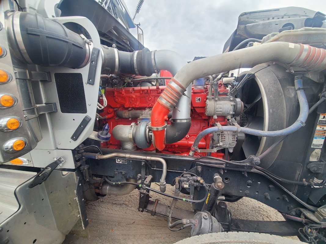 Red Cummins diesel engine open in truck cab